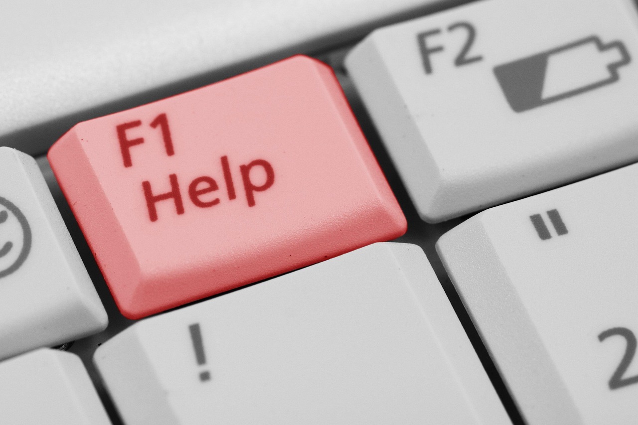 A pink key prominently displayed on a computer keyboard, contrasting with the standard black and white keys surrounding it