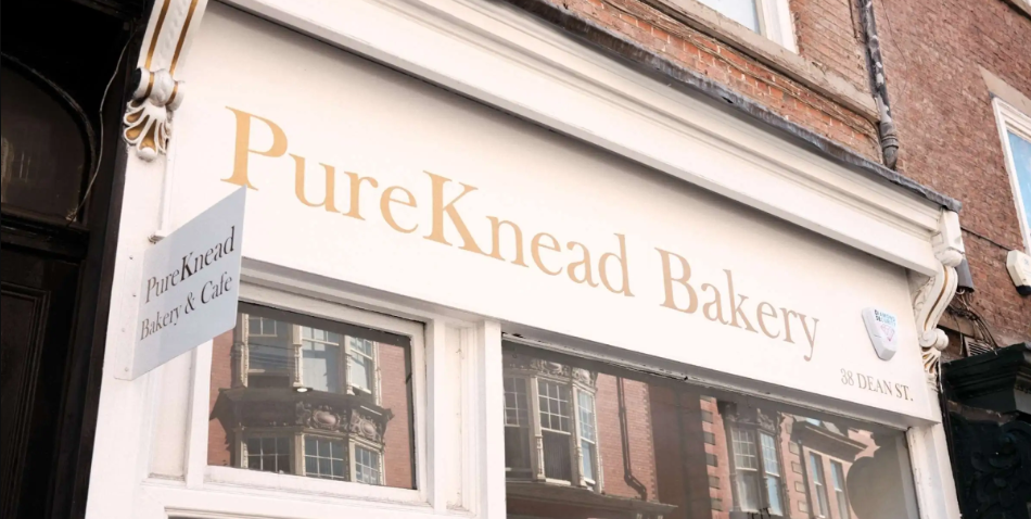 PureKnead Bakery storefront on Dean Street in a classic brick building reflecting neighbouring architecture