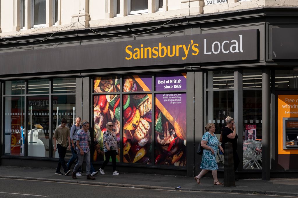 Sainsbury's Local store closing in London, with a sign indicating the closure and empty storefront
